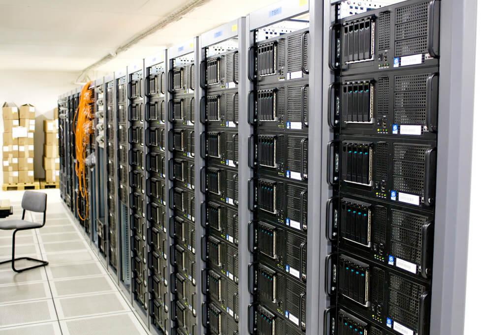 Showing a wall of servers in an office.