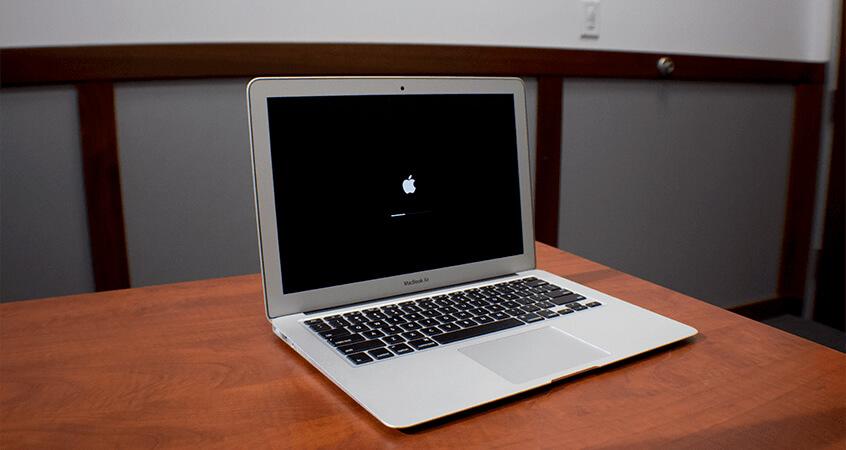 Showing a MacBook Air with the Apple Loading bar.